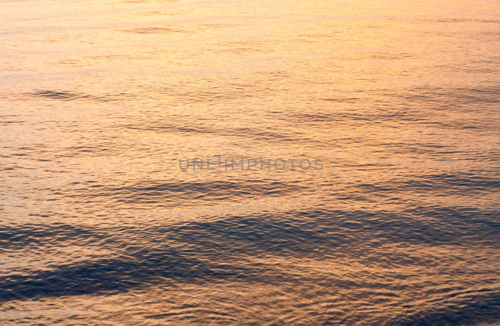 waves of the Mediterranean sea of ​​golden color at sunset 1
