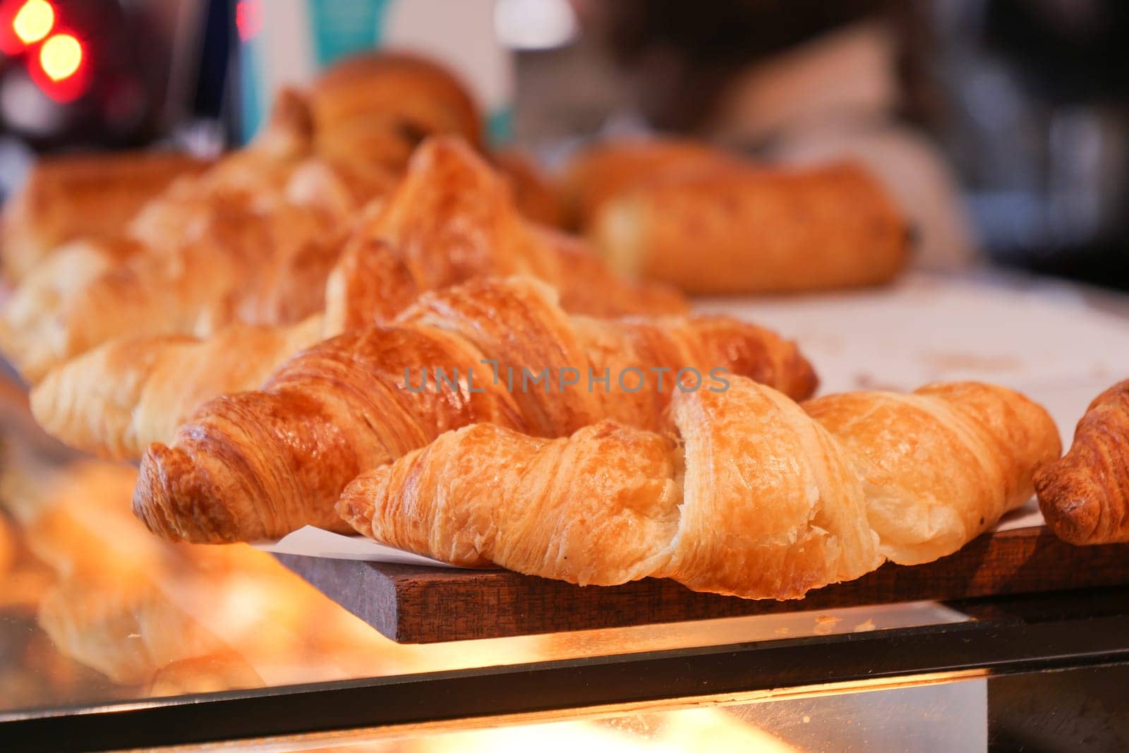 fresh baked croissant in a bakery .