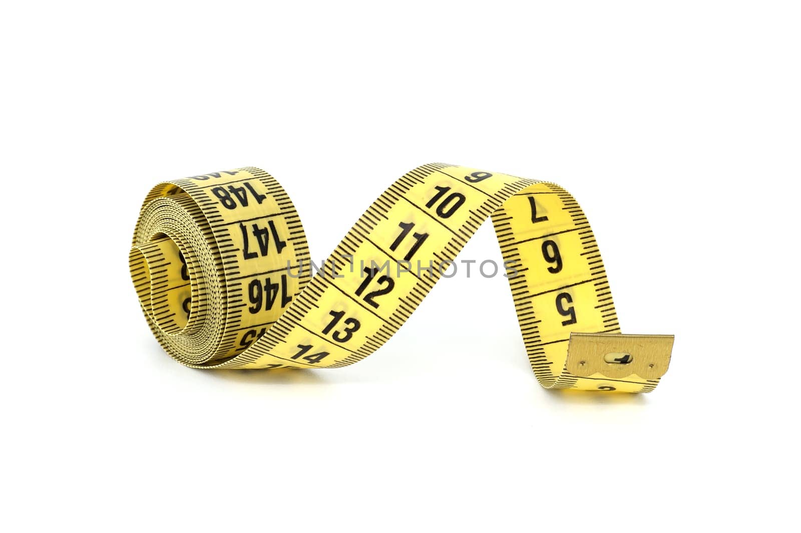 Yellow tape measure spirals creates a visual impression of motion isolated on white background