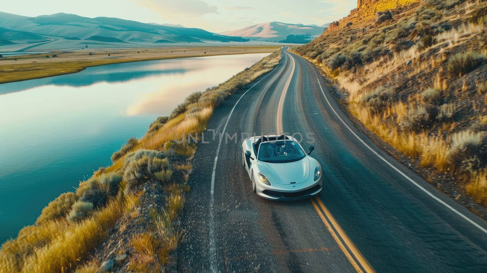 An super car drives along the road along the water reservoir ridge