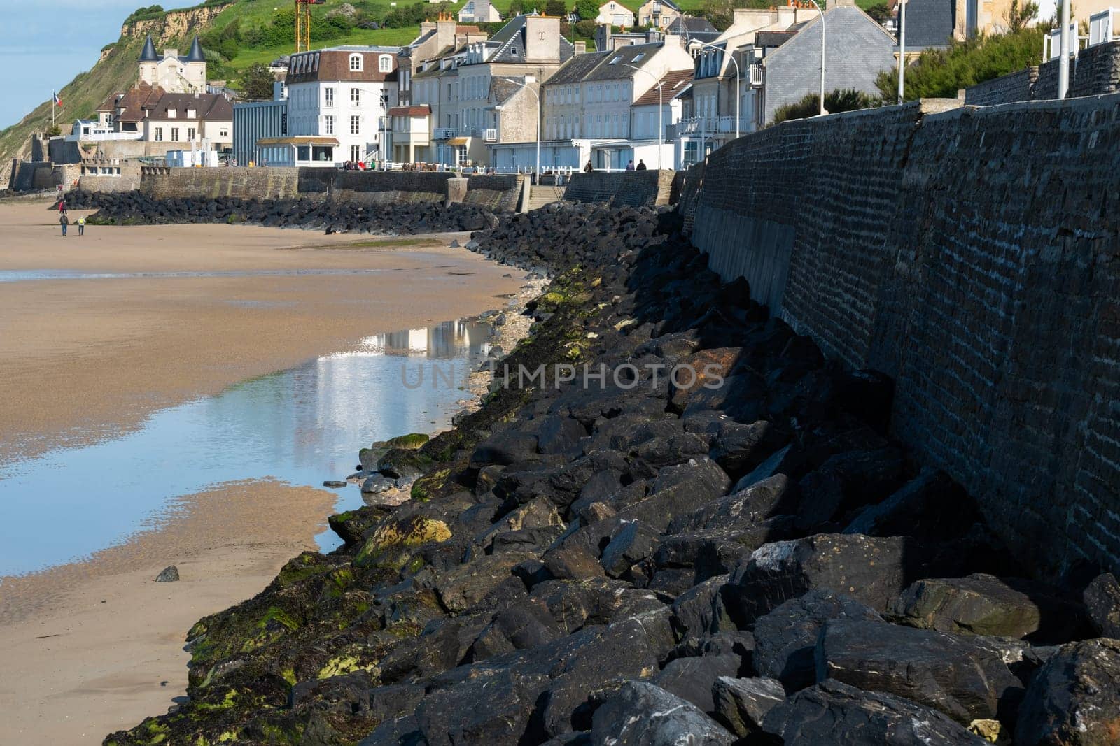 Normandy France Gold beach promenade. Sand sea and rock seawall. High quality photo