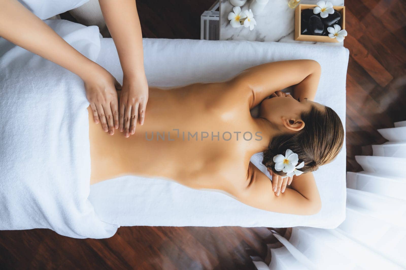 Panorama top view woman customer enjoying relaxing anti-stress spa massage and pampering with beauty skin recreation leisure in day light ambient salon spa at luxury resort or hotel. Quiescent