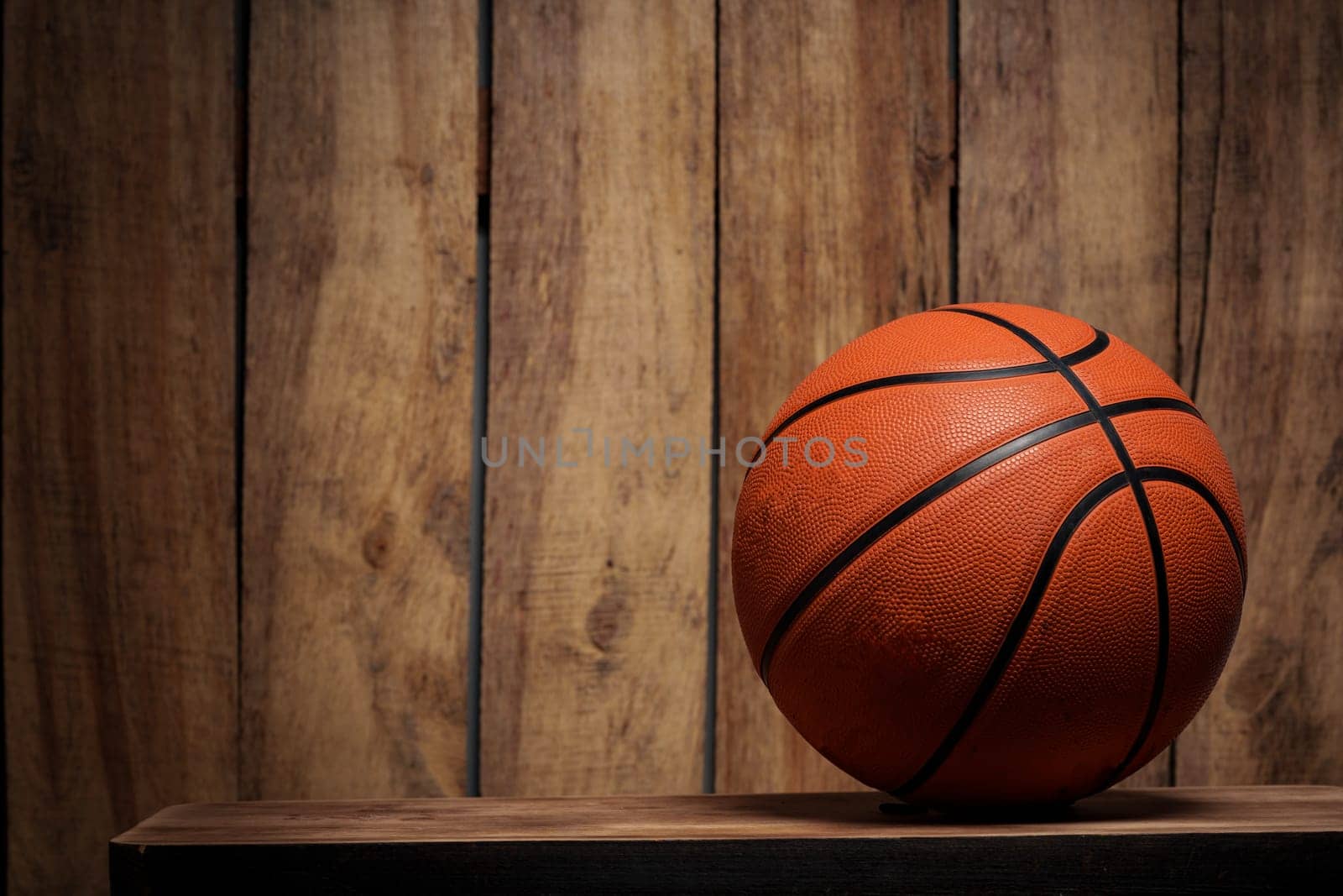 Basketball ball lying on a wooden floor close up