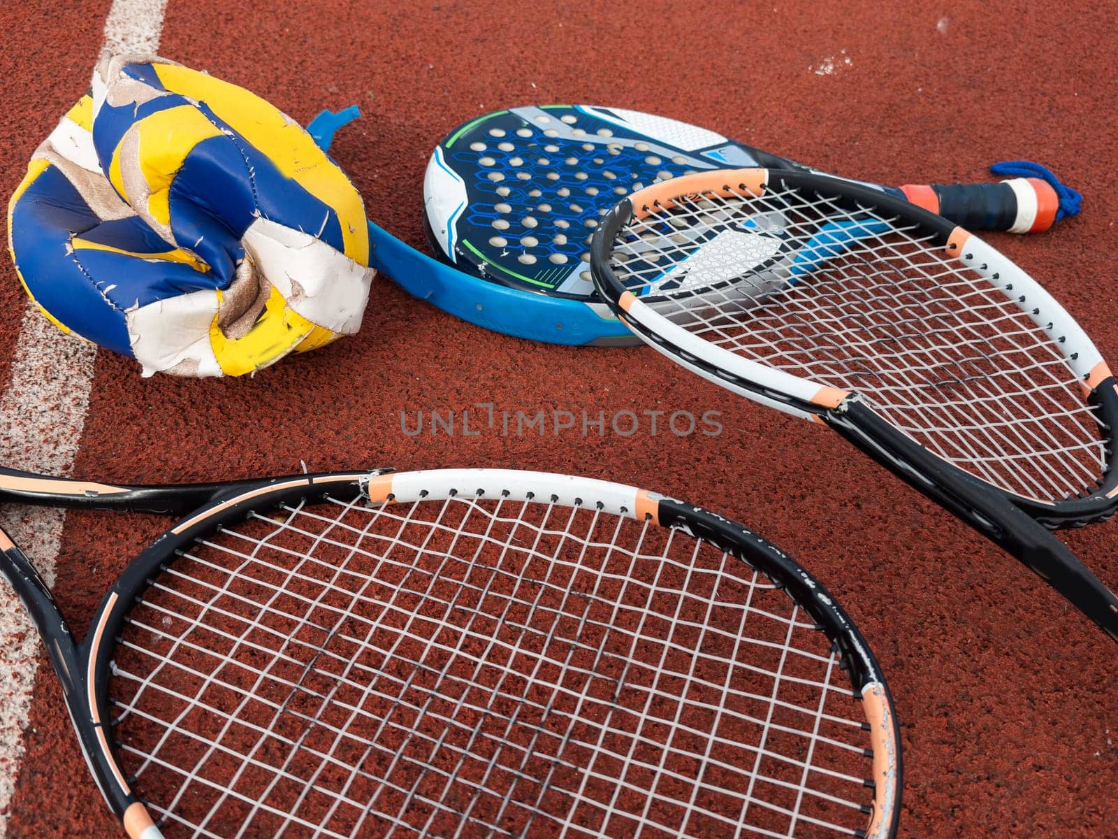 The broken rackets for playing tennis are hanging on the wall of a sports tennis club. . High quality photo