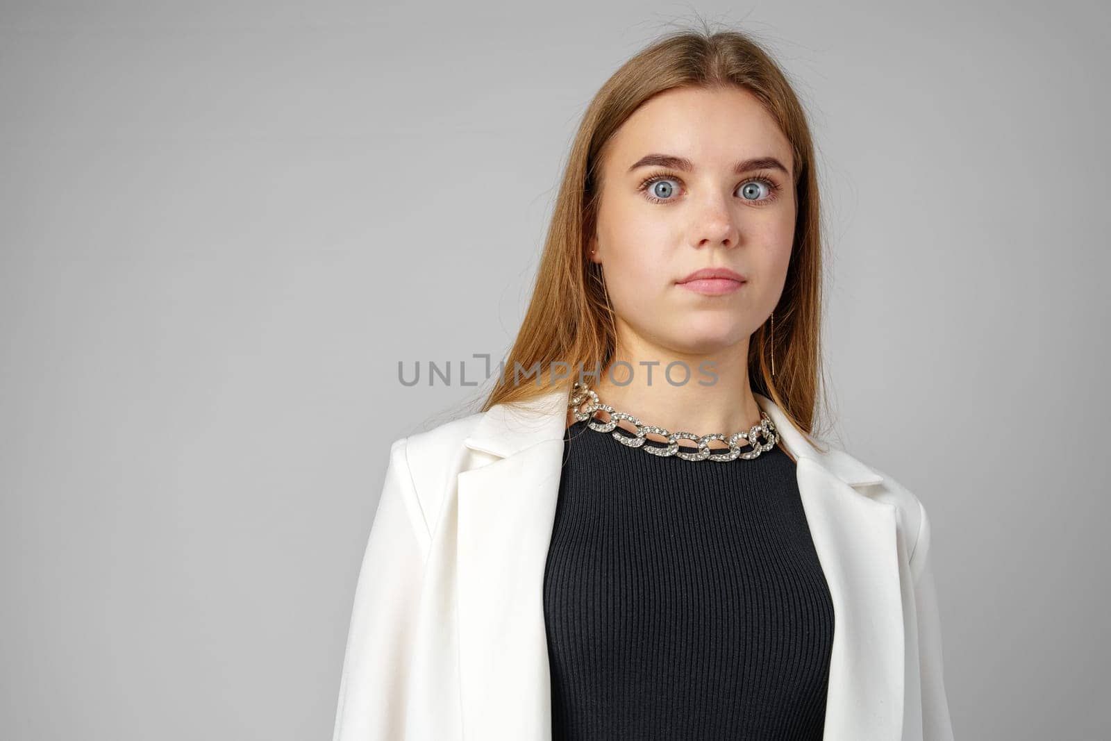 Woman Wearing White Jacket and Black Top close up