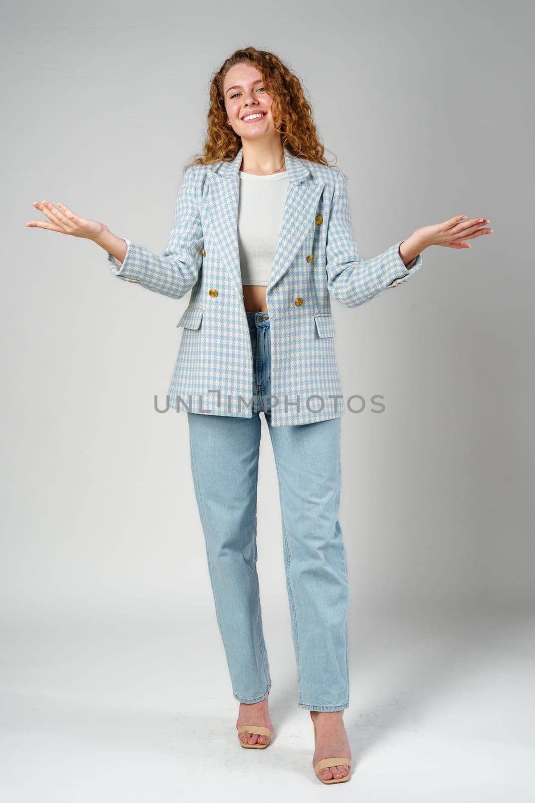 Woman in Blue and White Checkered Blazer Holding Out Arms close up