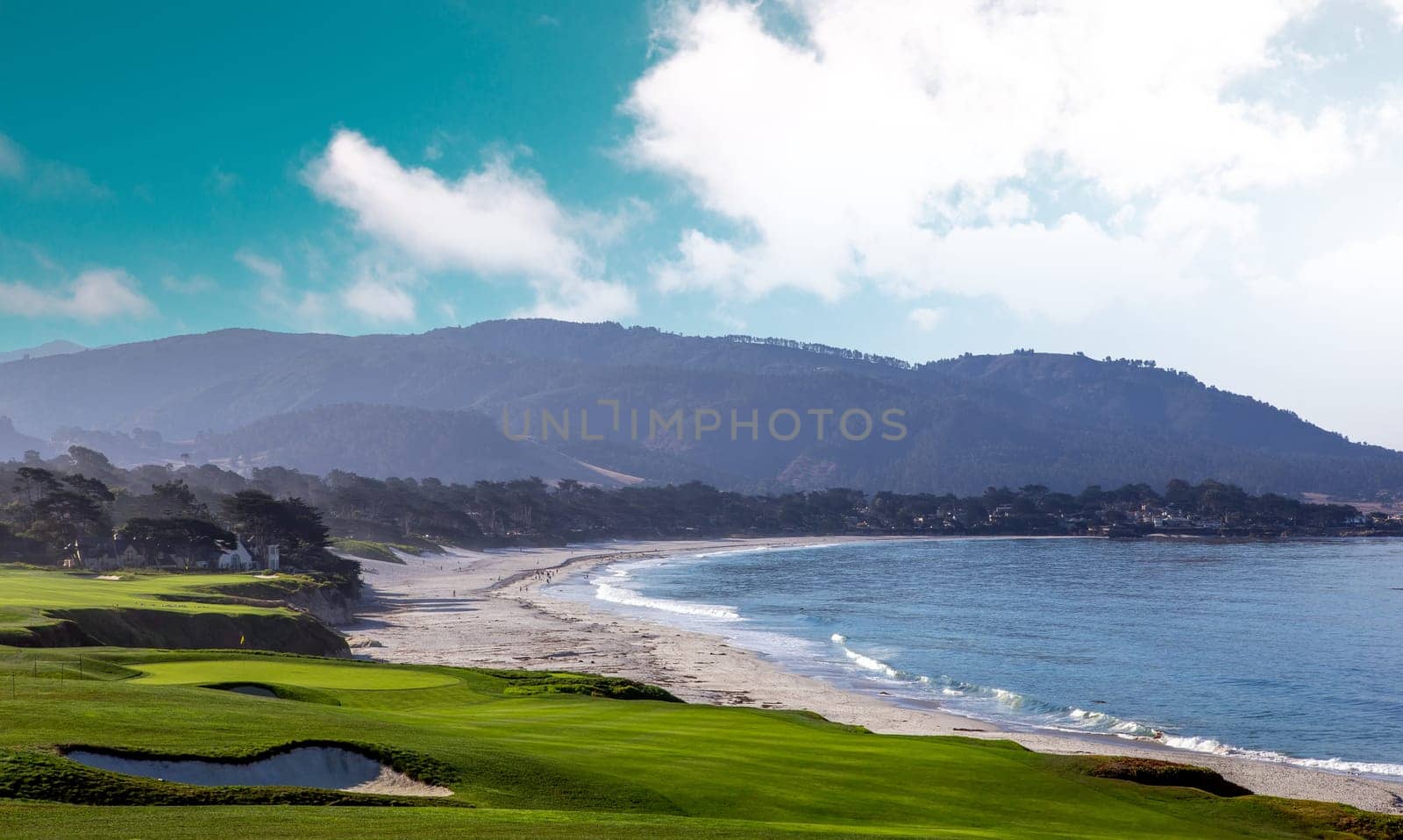 oceanside golf course with bunker,  ocean and clouds