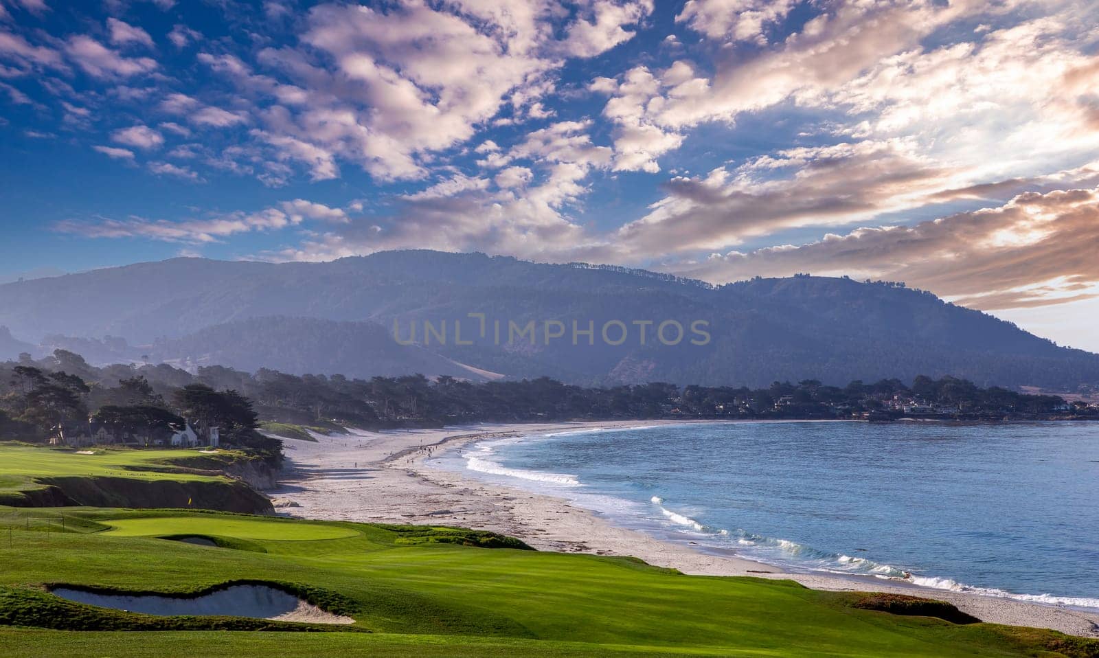 oceanside golf course with bunker,  ocean and clouds