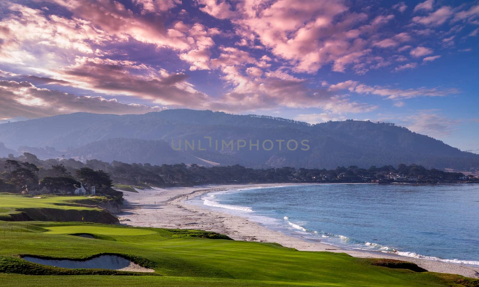 oceanside golf course with bunker,  ocean and clouds