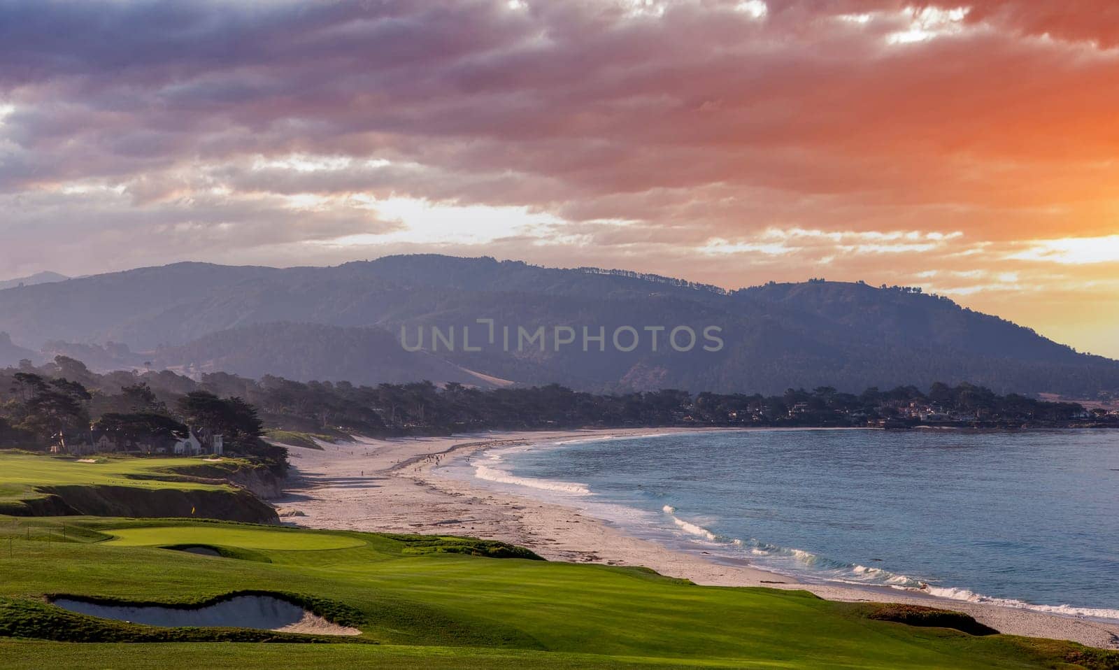 oceanside golf course with bunker,  ocean and clouds