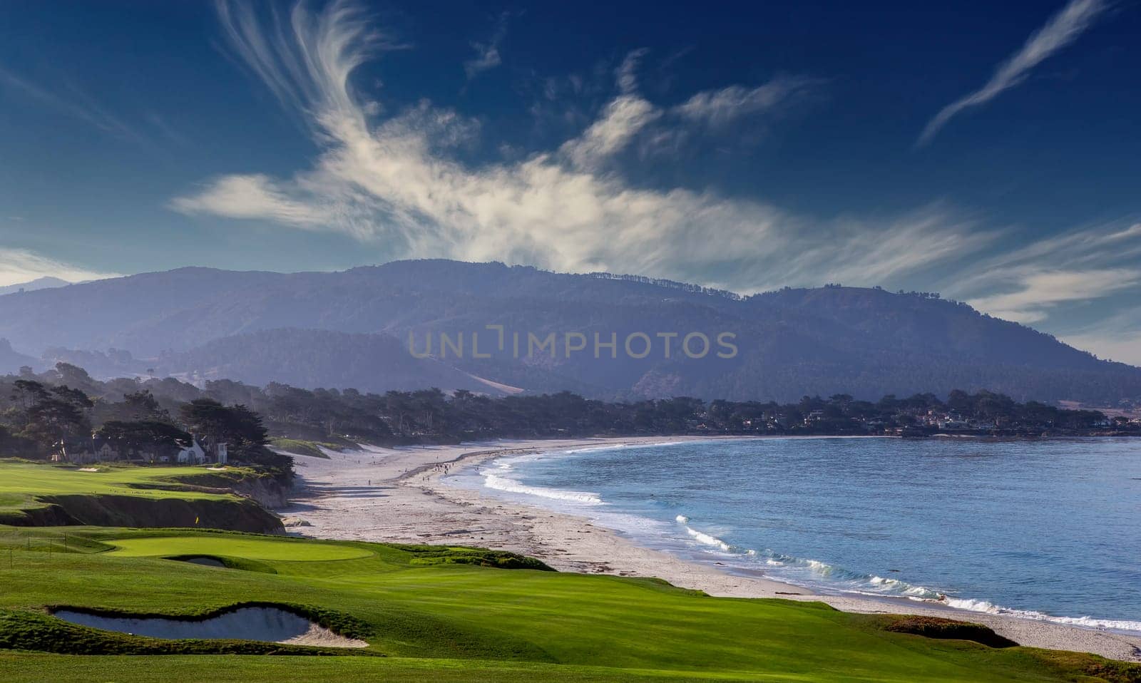 oceanside golf course with bunker,  ocean and clouds