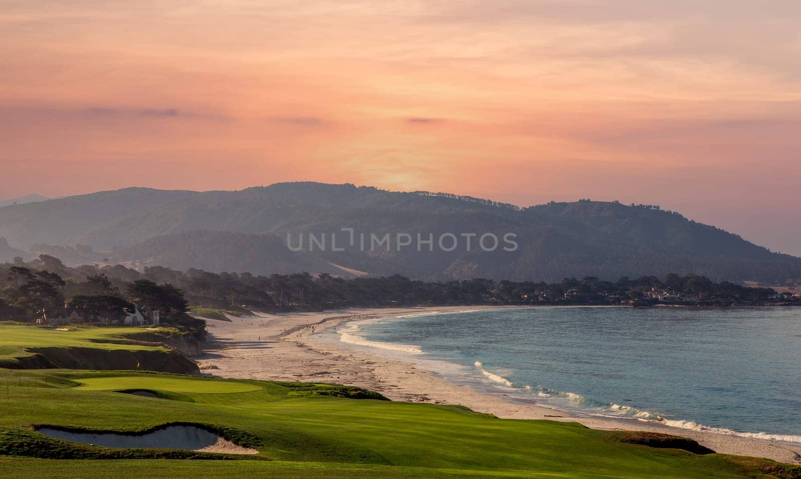 oceanside golf course with bunker,  ocean and clouds