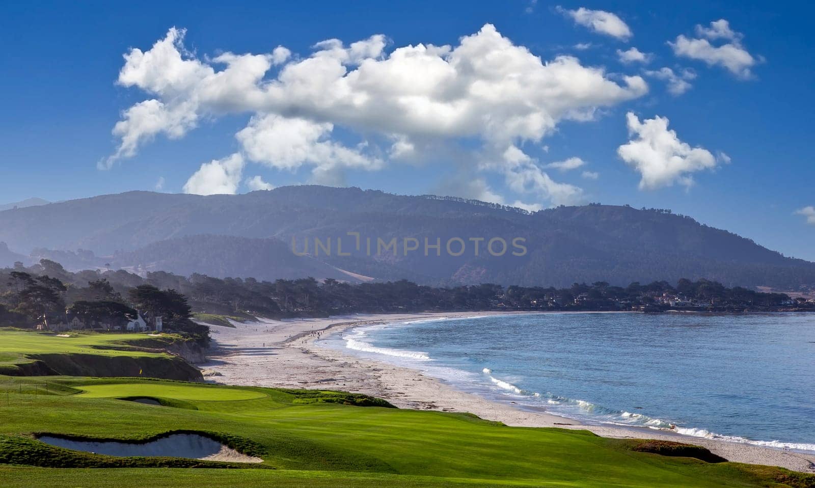 oceanside golf course with bunker,  ocean and clouds