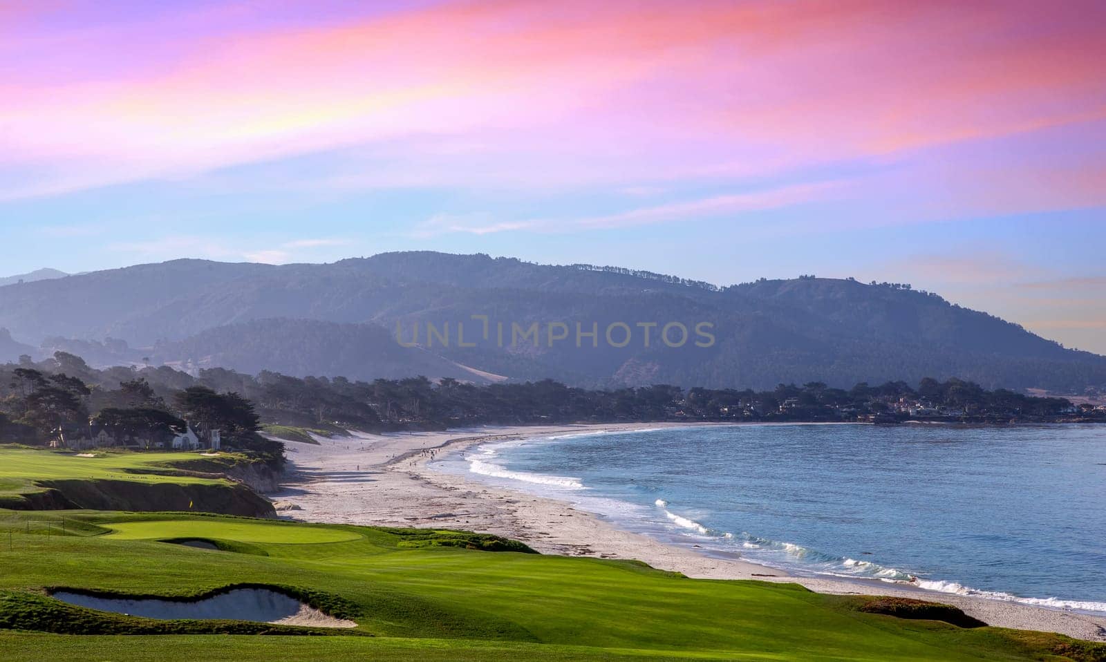 oceanside golf course with bunker,  ocean and clouds