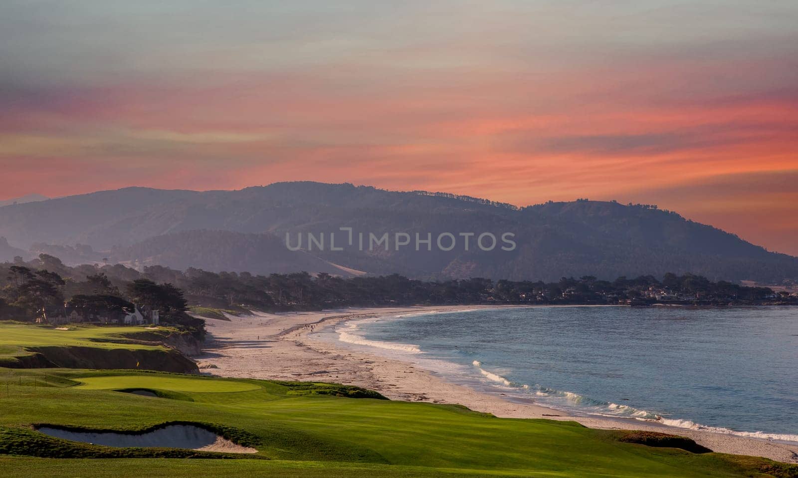 oceanside golf course with bunker,  ocean and clouds