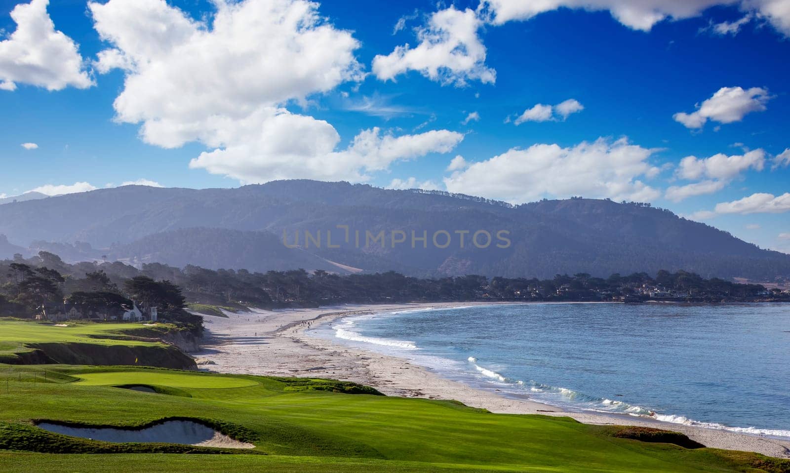 oceanside golf course with bunker,  ocean and clouds