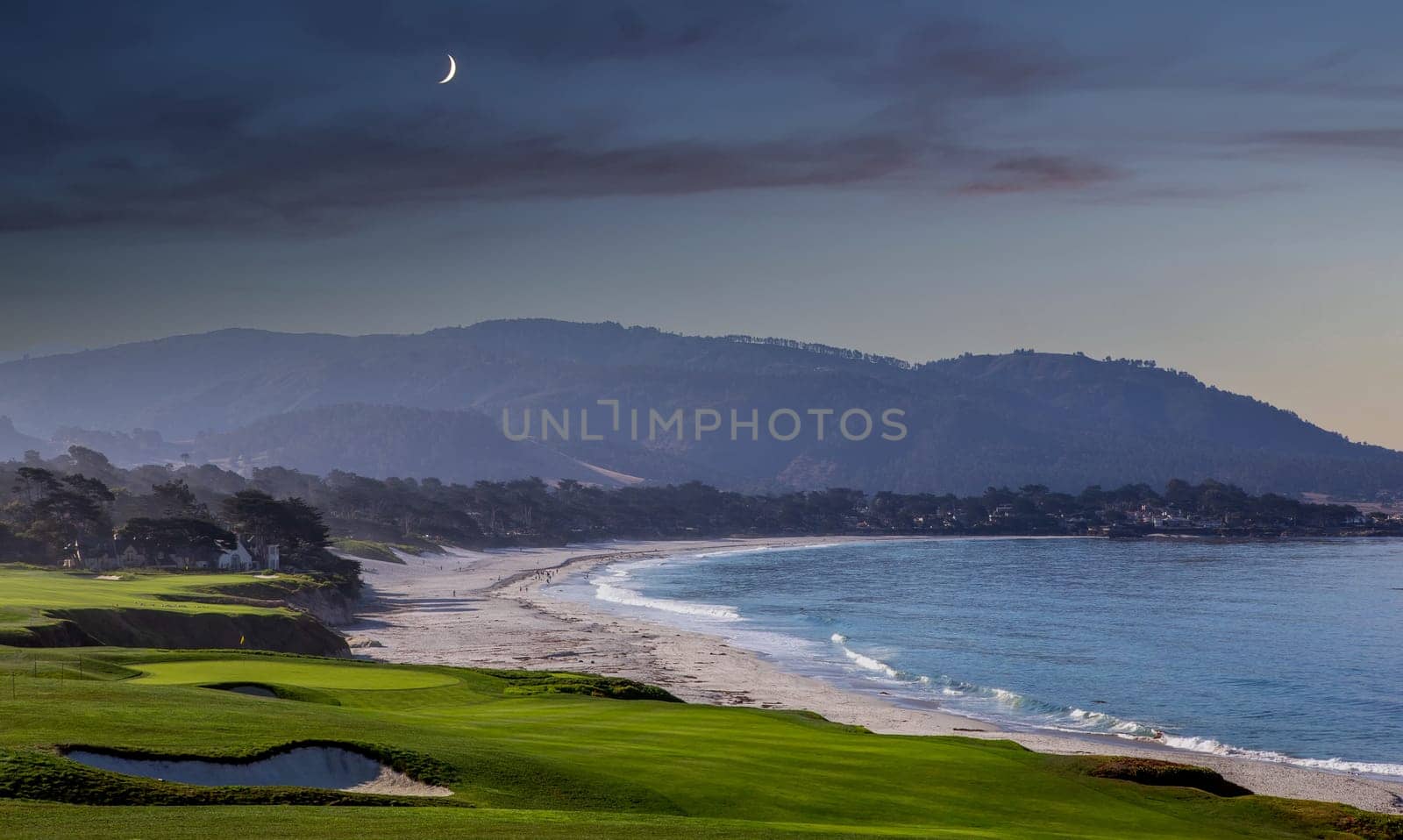 oceanside golf course with bunker,  ocean and clouds