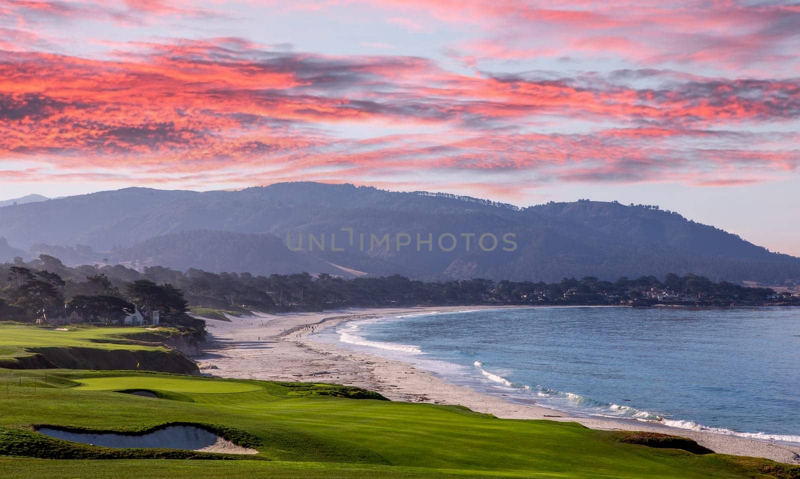 oceanside golf course with bunker,  ocean and clouds