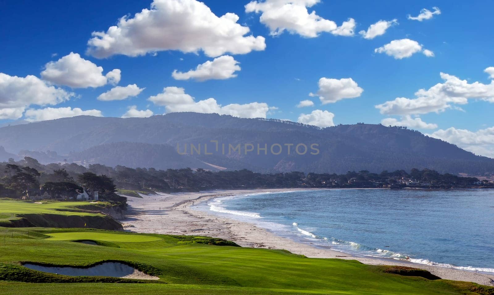 oceanside golf course with bunker,  ocean and clouds