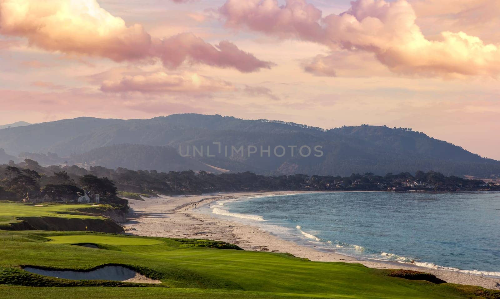 oceanside golf course with bunker,  ocean and clouds