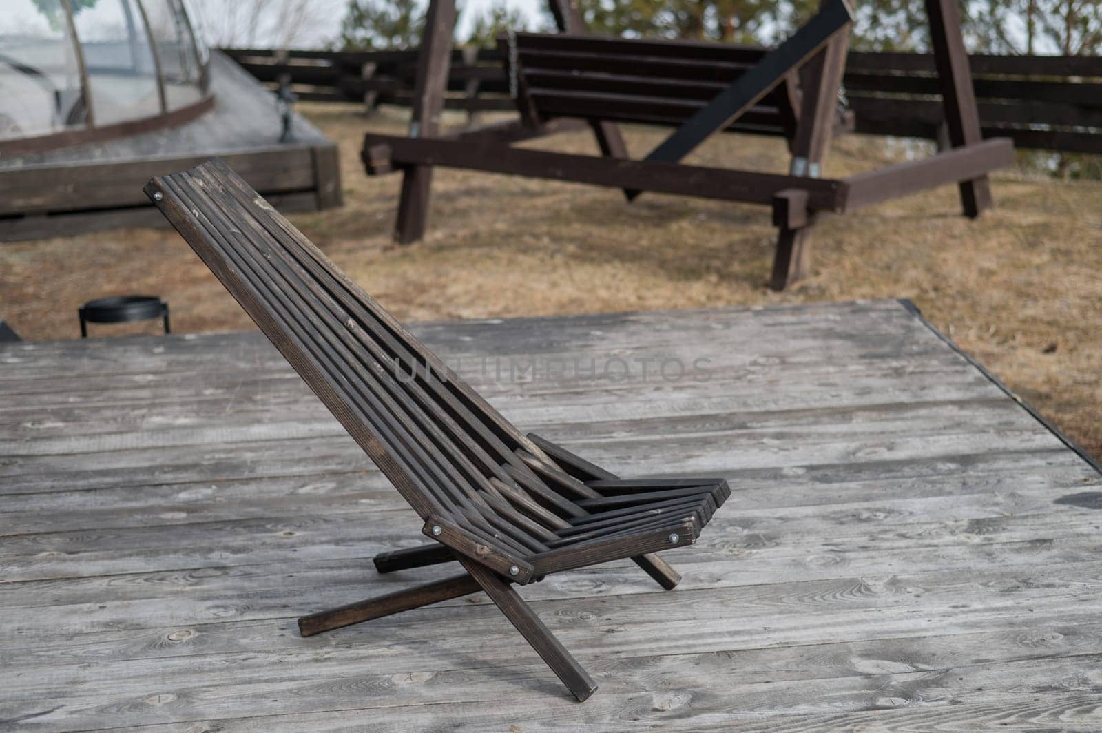 Empty wooden deck chair outdoors