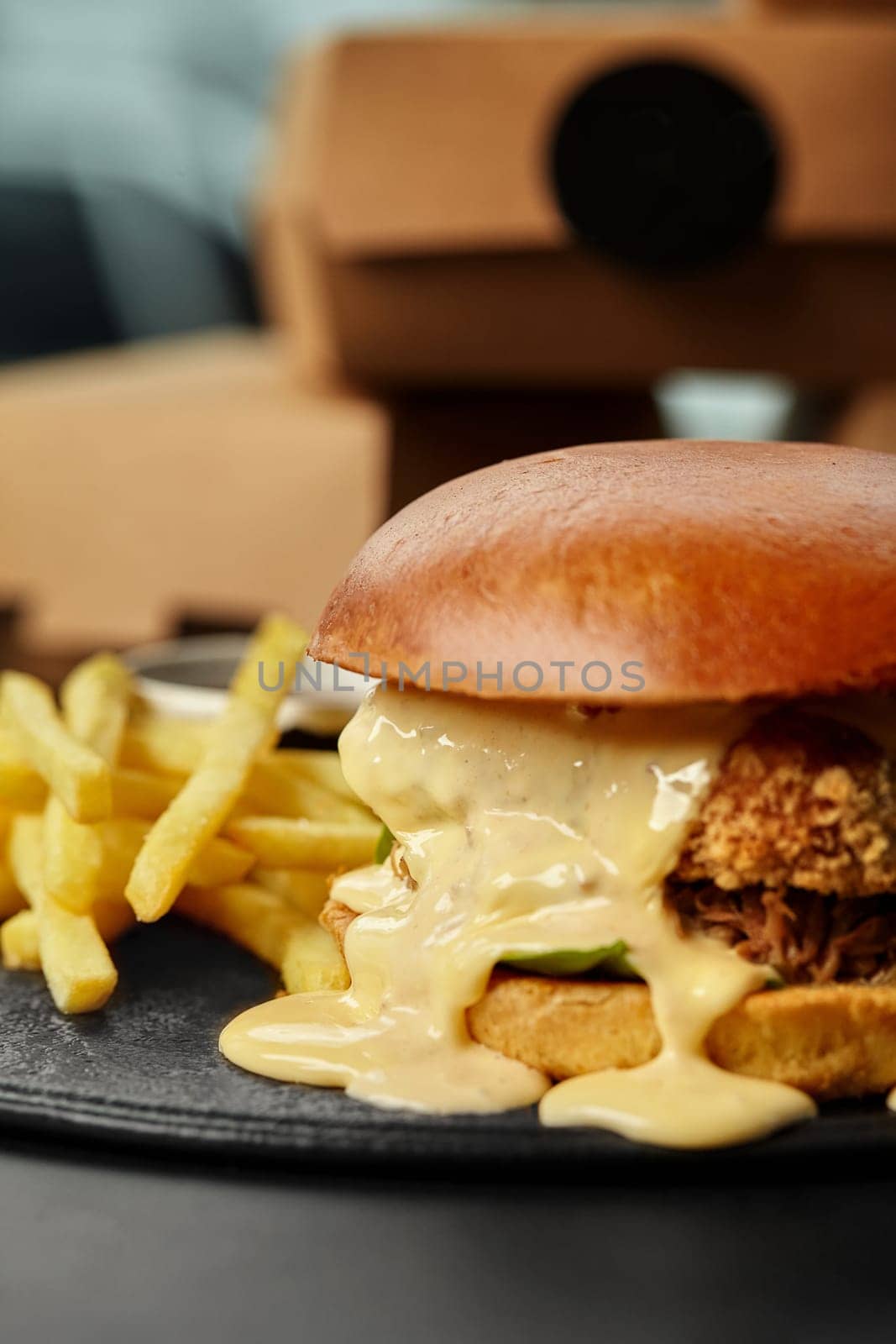 Chicken burger with cheese sauce, fried onions and fries by nazarovsergey