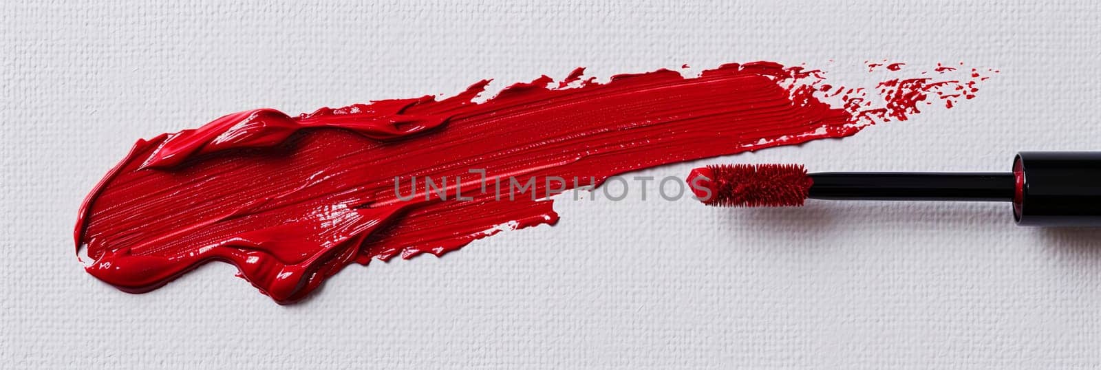 Red lipstick leaves a striking swatch on white surface, creating a dramatic and alluring scene.