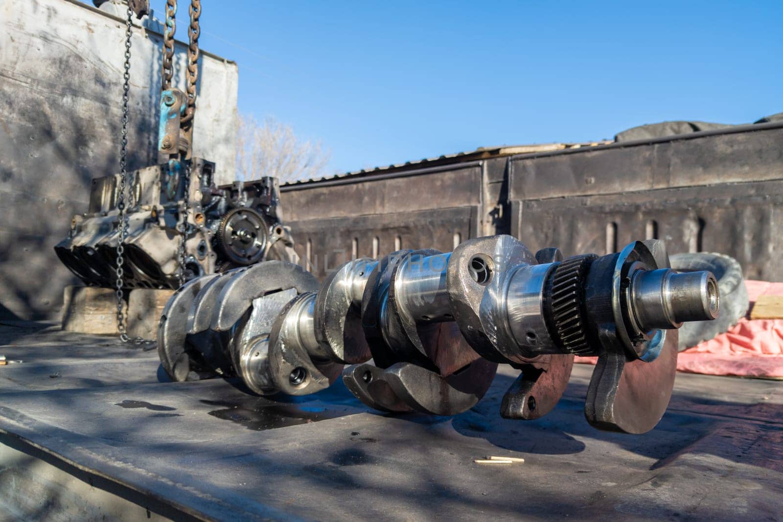 Closeup of a soviet truck engine crankshaft laid on truck bed.