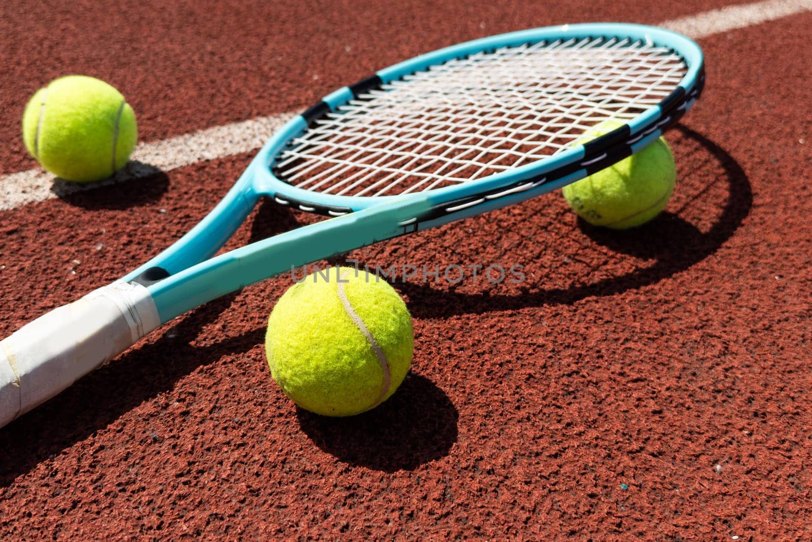 Tennis scene with balls, racquets and hard court surface corner lines. High quality photo