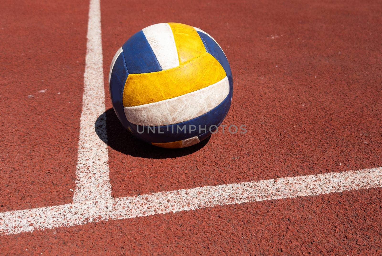 volleyball. blue with yellow color ball on the playground. volleyball cover, red. ball game. High quality photo