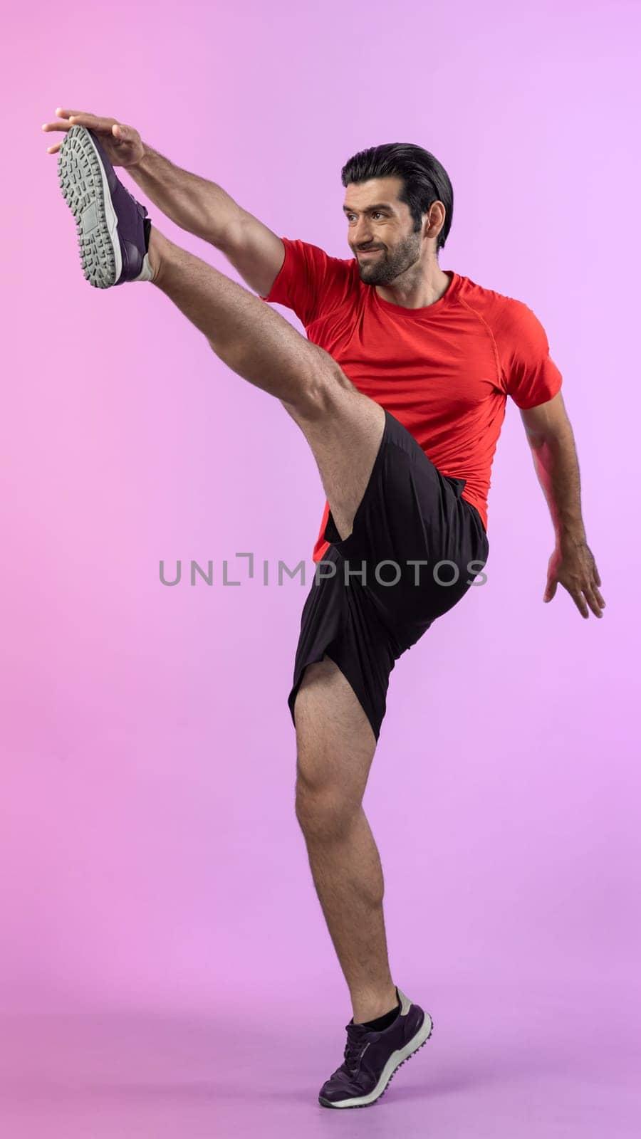 Full body length gaiety shot athletic and sporty young man with fitness in cardio exercise, kicking position posture on isolated background. Healthy active and body care lifestyle.