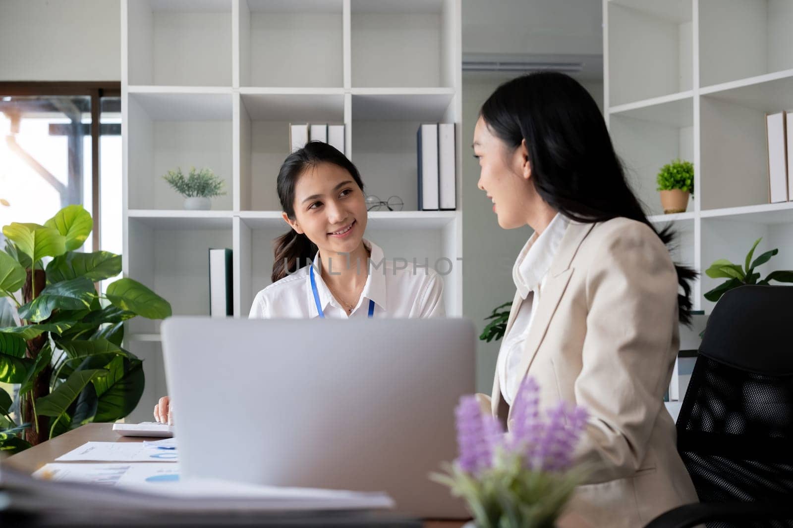 Team businesswomen discussing financial reports in office.