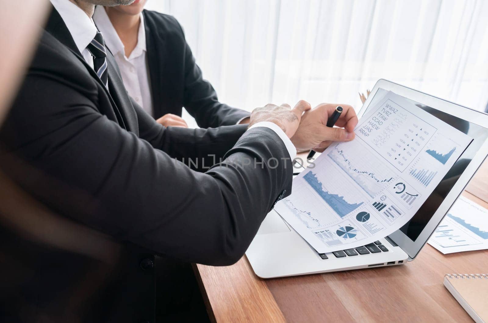 Diverse group of business analyst team analyzing financial data report paper on office table. Chart and graph dashboard by business intelligence analysis for strategic marketing planning Habiliment