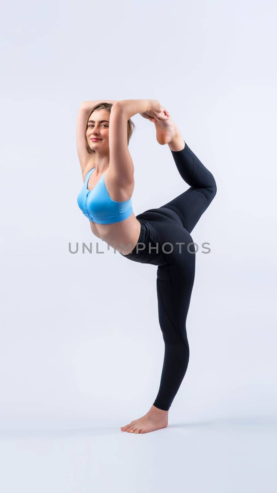 Full body length gaiety shot athletic and sporty woman doing yoga by biancoblue