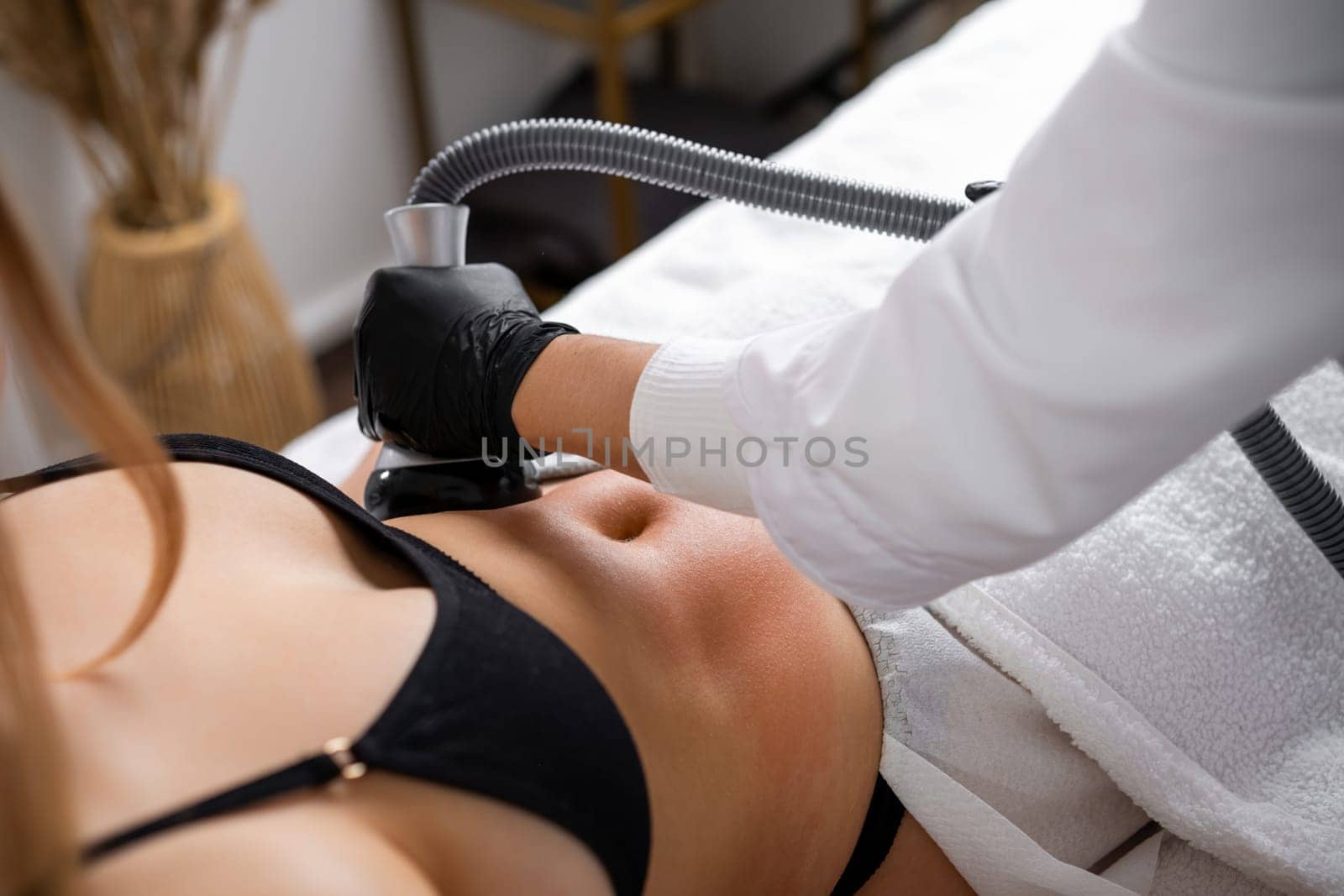 Client opts for cavitation therapy to diminish fat on belly. Ultrasonic procedure stimulates collagen production contributing to smoother skin