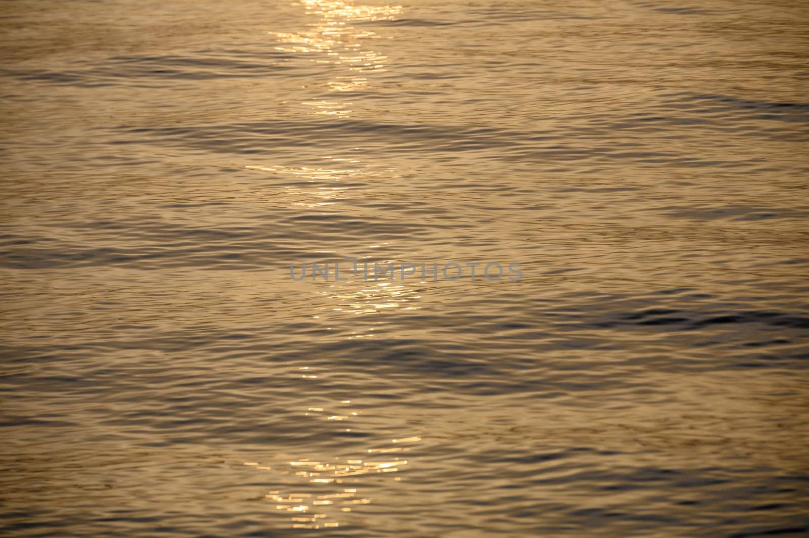 sun sets on a dramatic cloudy sky over the Mediterranean Sea horizon with a warm, golden glow.1 by Mixa74