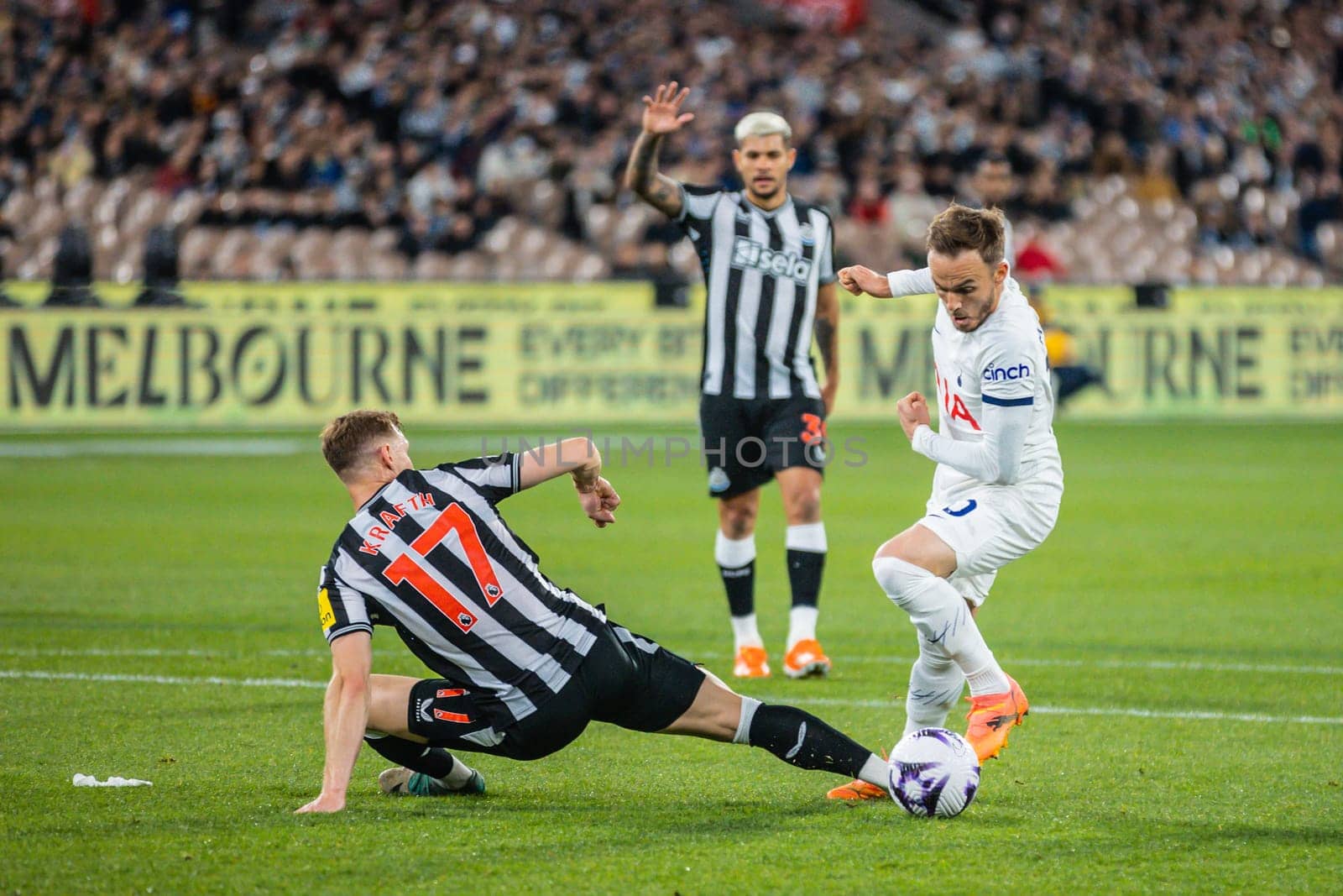 MELBOURNE, AUSTRALIA - MAY 22: James Maddison of Tottenham Hotspur sidesteps Emil Krafth of Newcastle United during the Global Football Week at The Melbourne Cricket Ground on May 22, 2024 in Melbourne, Australia