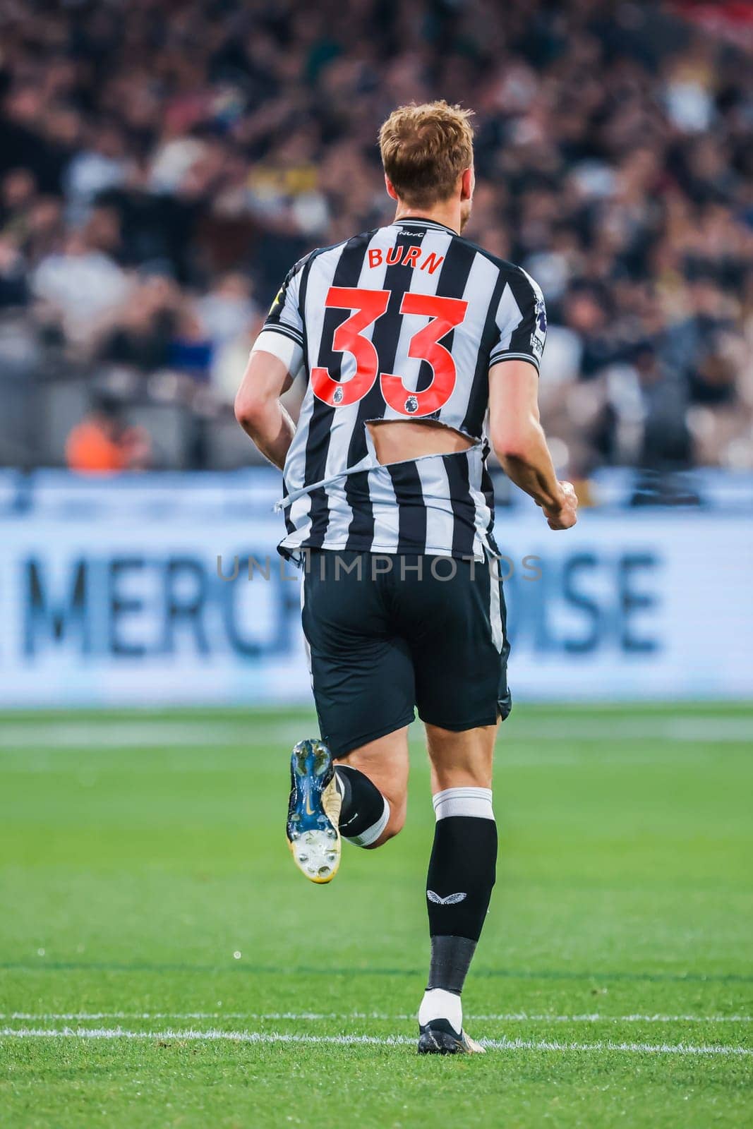 MELBOURNE, AUSTRALIA - MAY 22: Dan Burn of Newcastle United with a ripped shirt whilst playing Tottenham Hotspur during the Global Football Week at The Melbourne Cricket Ground on May 22, 2024 in Melbourne, Australia