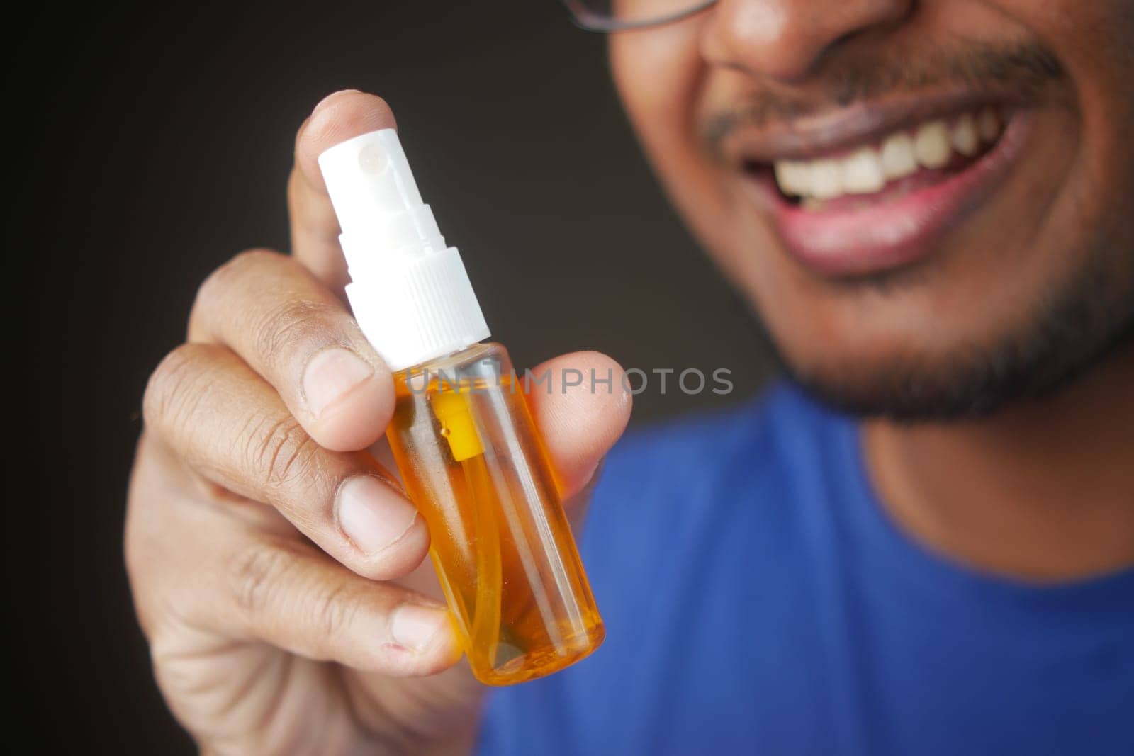 Young Man holding a Fresh Breath Spray,