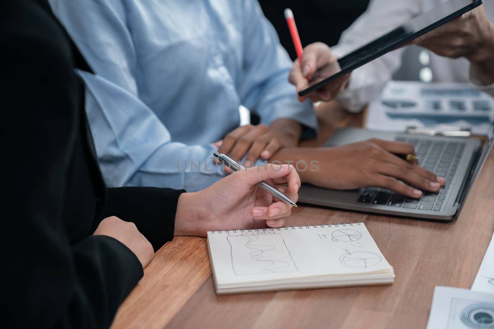 Diverse business people work together, discuss in corporate office. Professional teamwork discussing and pointing at laptop. Modern multicultural office worker. Concord