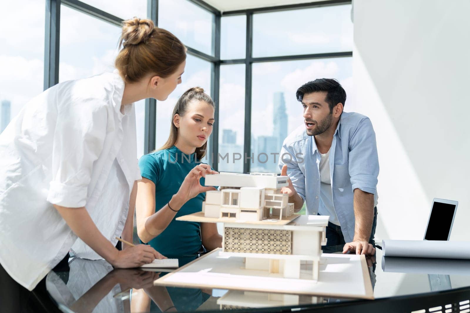 Professional diverse architect engineer team working together to design house model. Group of successful business team discussing and brainstorming about house structure. Civil engineering. Tracery.