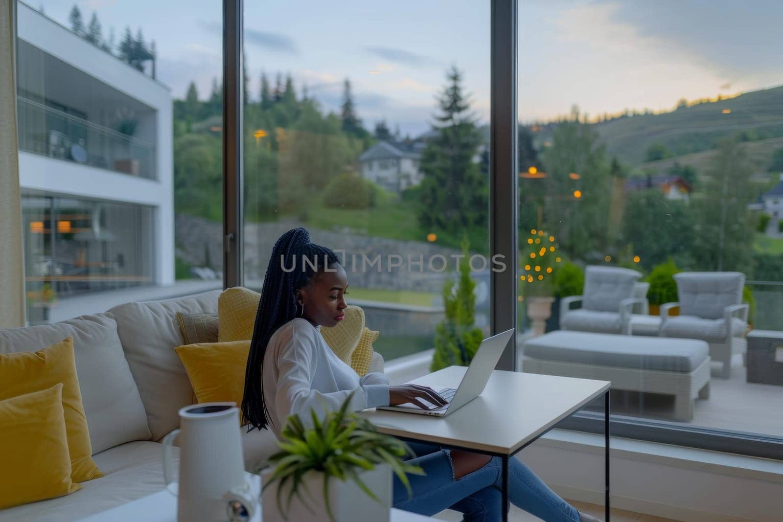 American African woman working with laptop at luxury home.