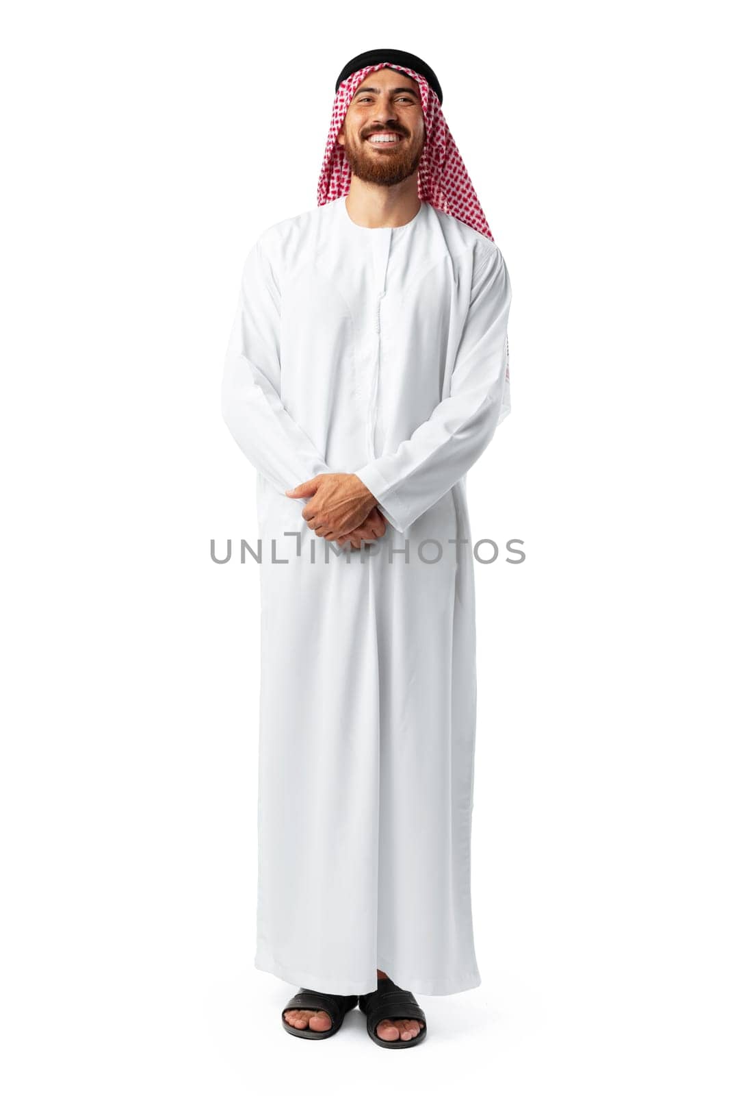 Smiling arab man while standing in an isolated white studio