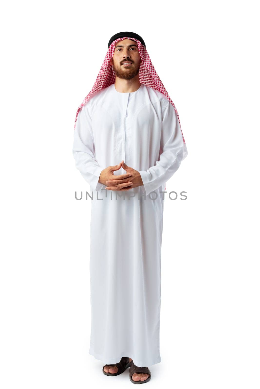 Smiling arab man while standing in an isolated white studio