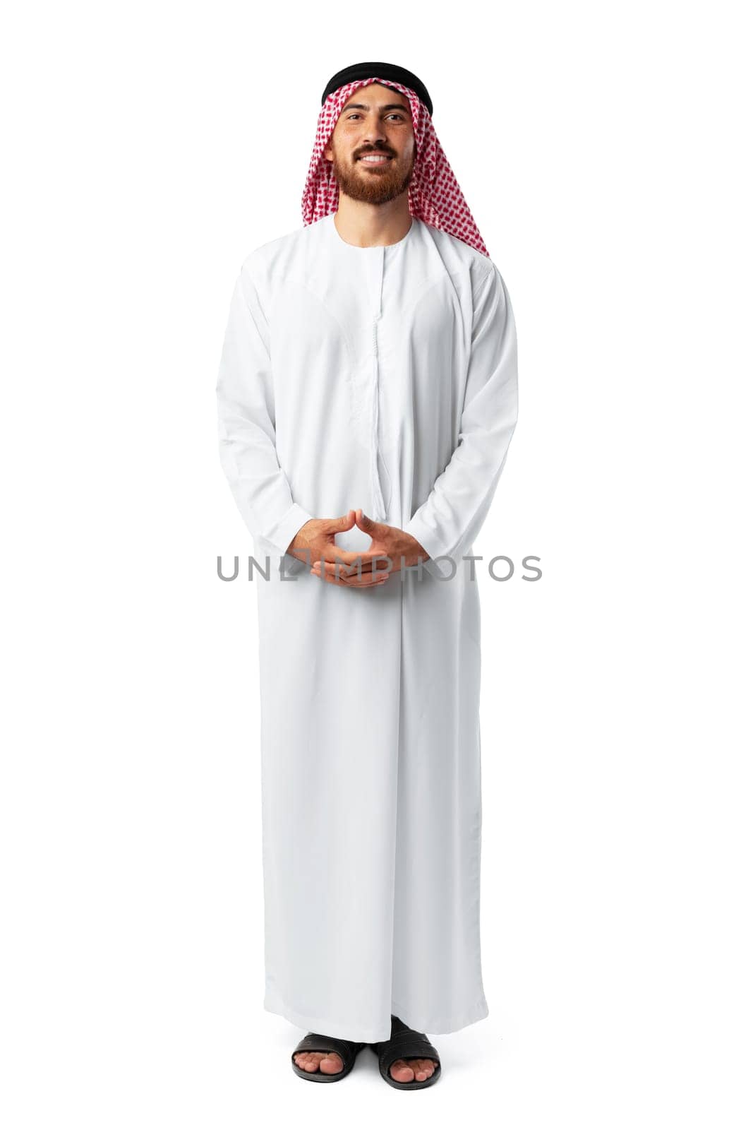 Smiling arab man while standing in an isolated white studio