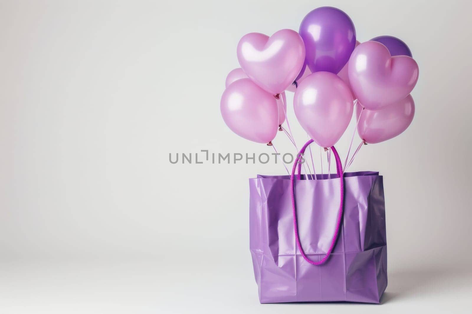 A purple bag with pink and purple balloons inside. The balloons are arranged in a way that they look like hearts. The bag is placed on a white background