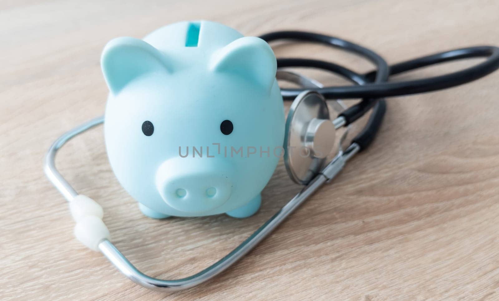 Piggy bank with medical equipment on the table medical concepts and health insurance. High quality photo