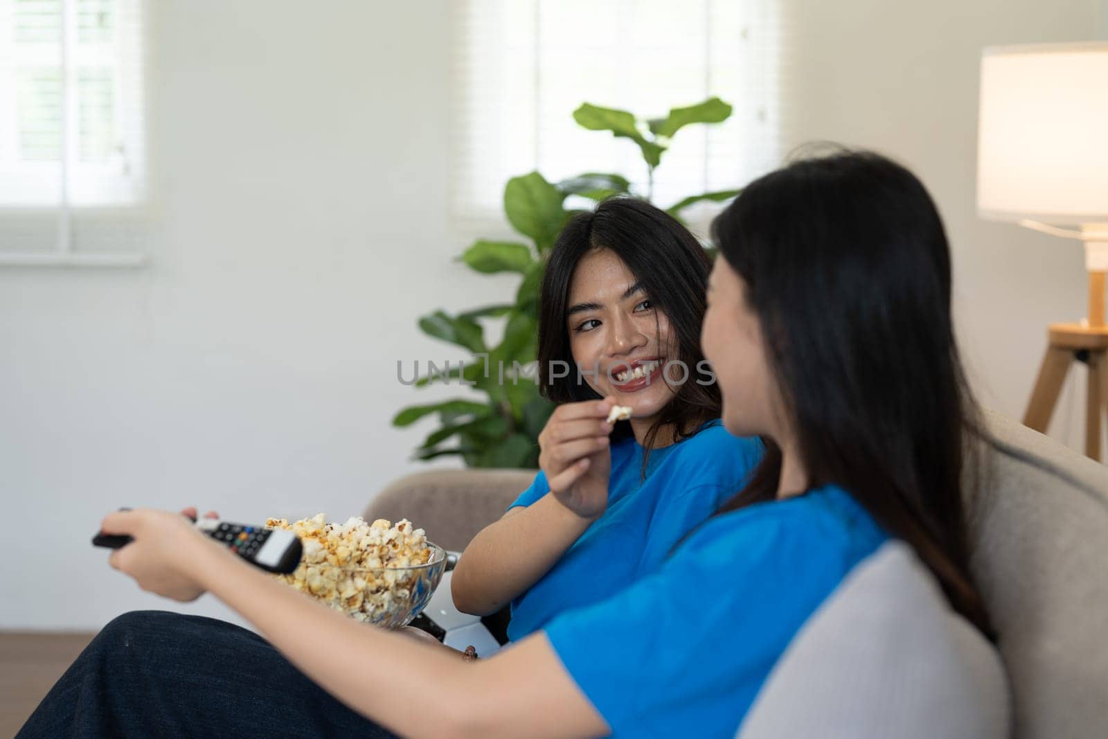 LGBT Soccer fans emotionally watching game in the living room.