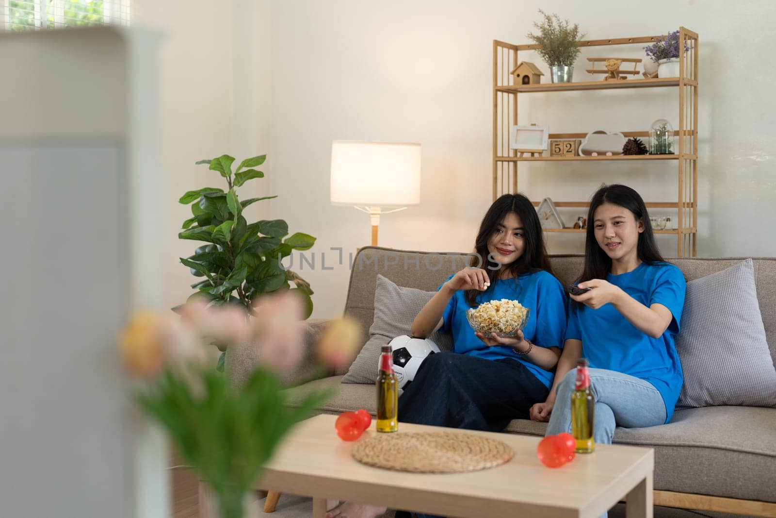 LGBT Soccer fans emotionally watching game in the living room.