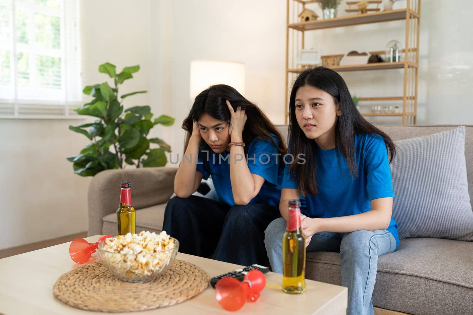 LGBT Soccer fans emotionally watching game in the living room.